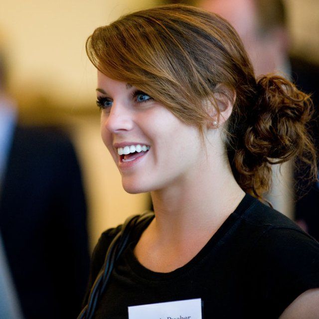 Female student smiling as she listens to a presentation during at Toast at the Point