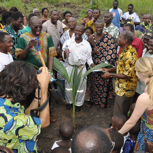 A group celebrates planting a new tree at the Human Factor Leadership Academy in Ghana.