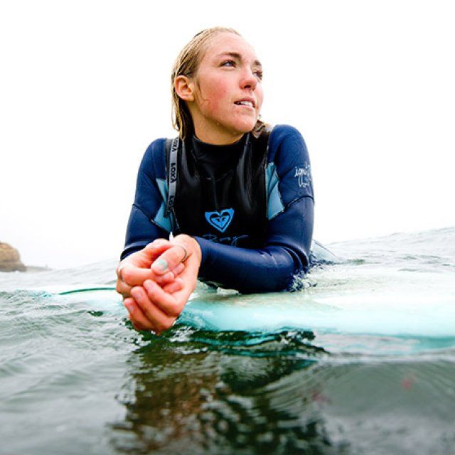Molly Guldin looks out for the next wave coming in while surfing off Sunset Cliffs.