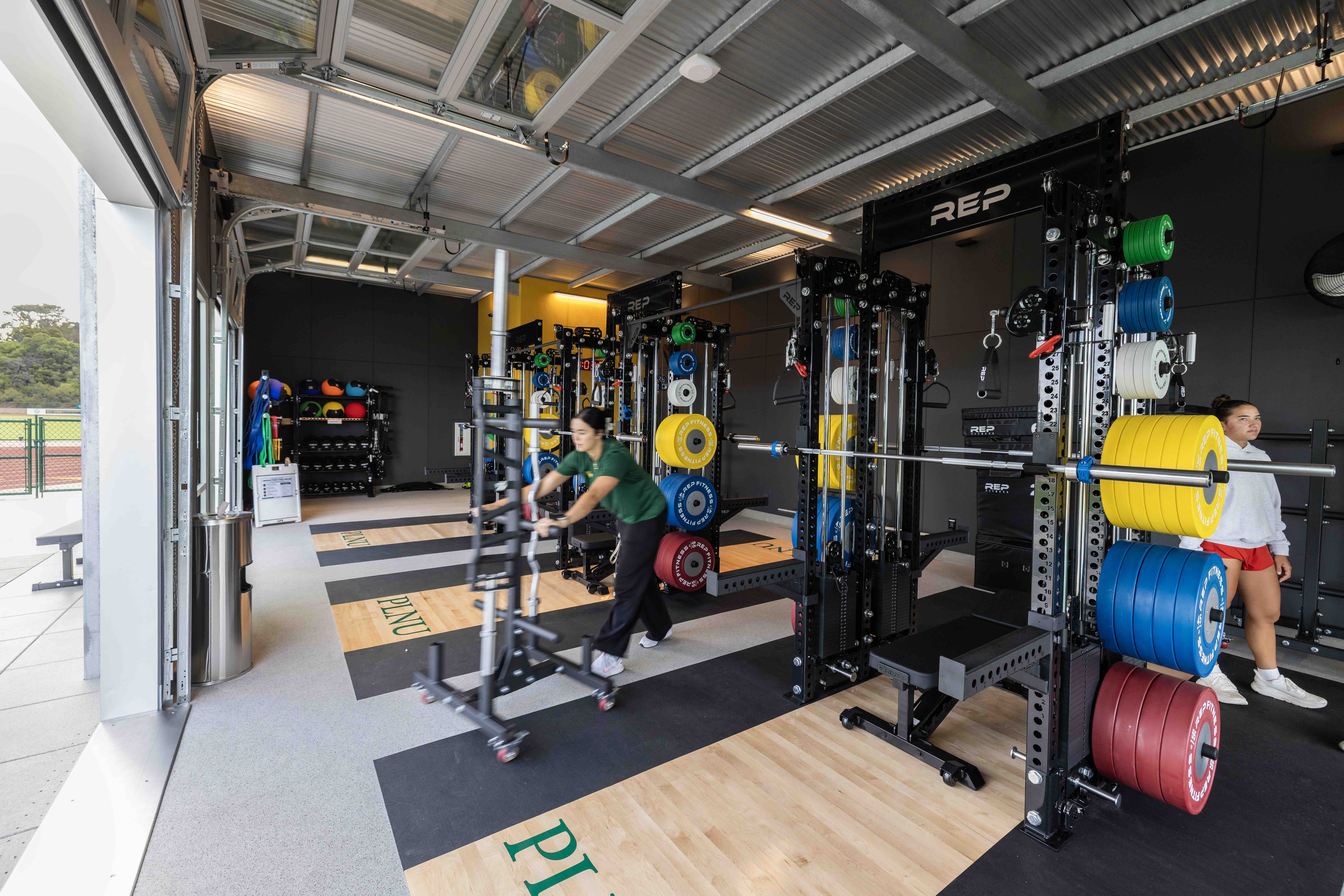 Students using strength training equipment inside the Lawrence Ryan Fitness Pavilion.