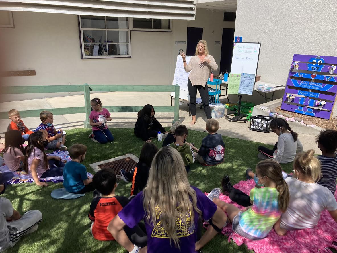 Angie Winkler teaching students a lesson outdoors.