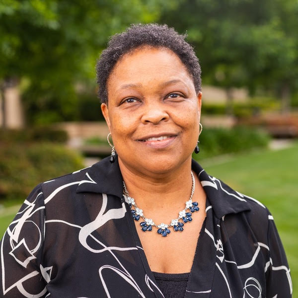 Photo of Denise P. Reid in black shirt.