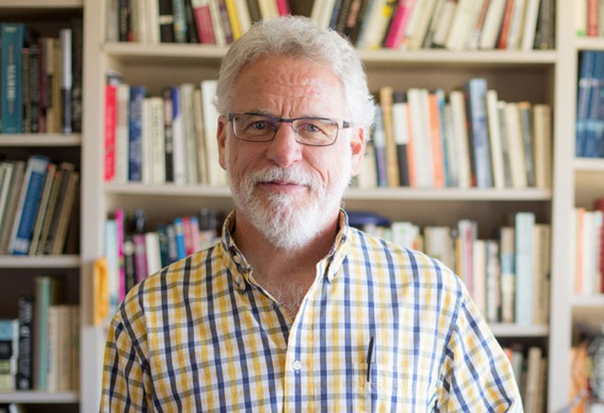 Dr. Karl Martin, professor of literature, sits in his office.