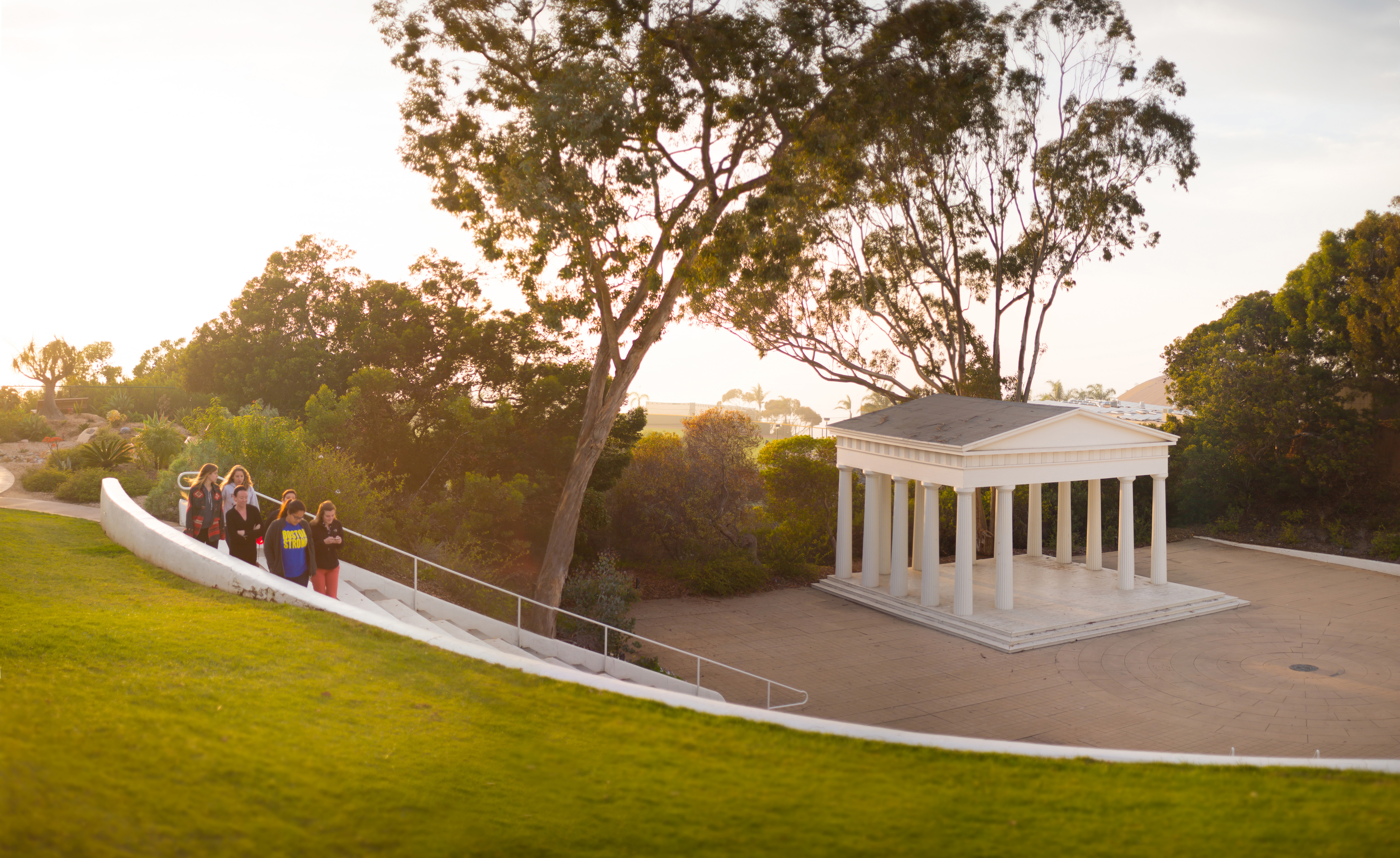 A group of students walk past the Greek Amphitheatre.