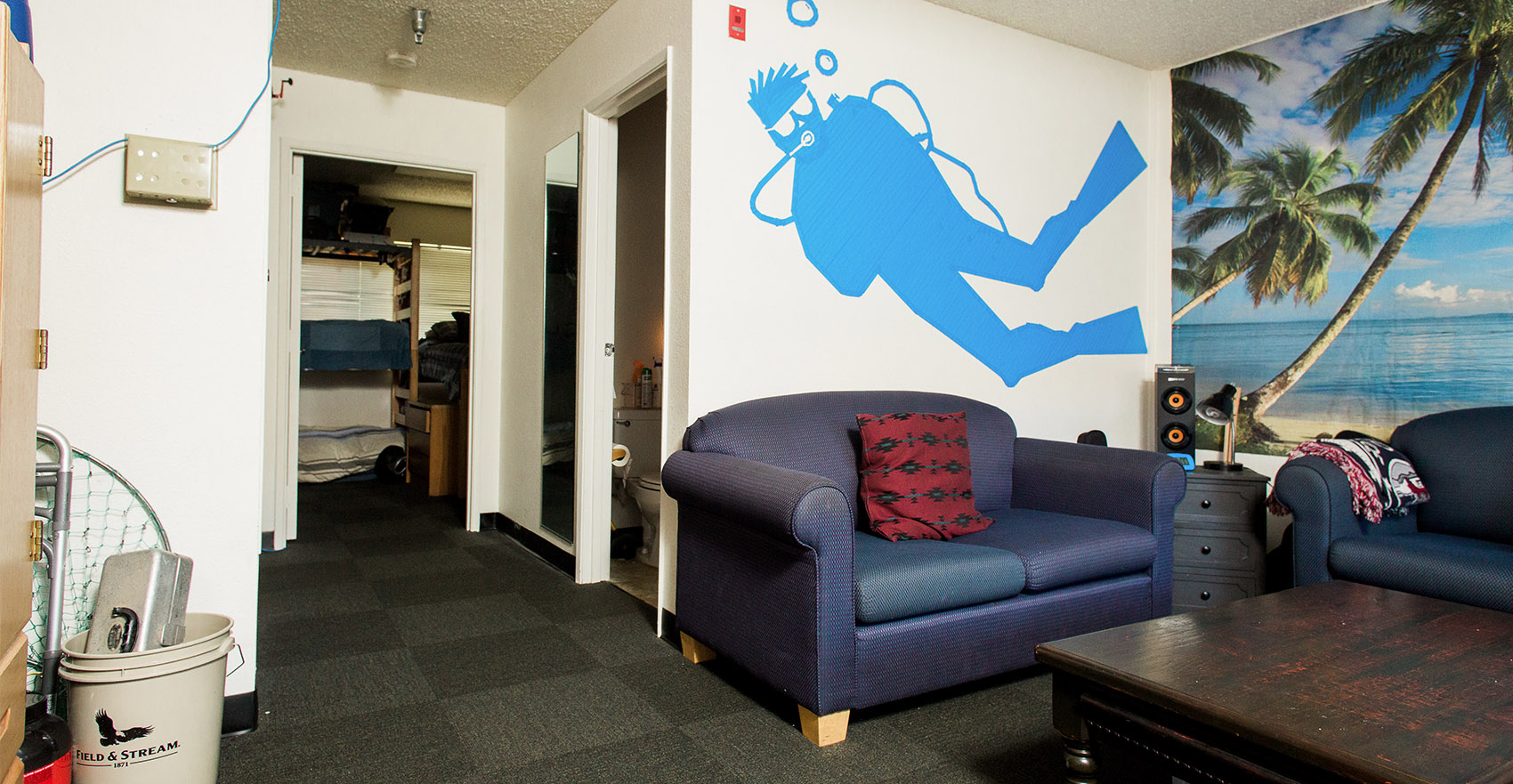 A lounge in Wiley Hall, complete with sofas and ocean themed wall art.