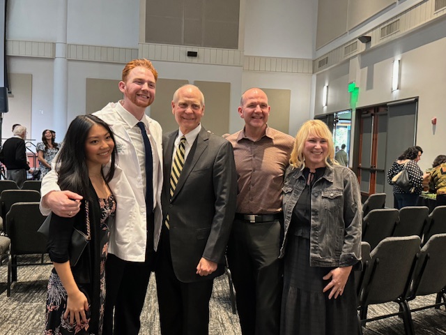 Student Poses With Faculty 