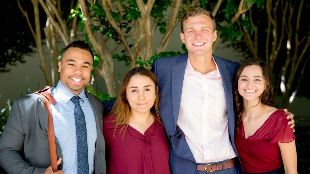 Group of PLNU business students gather together for a photo