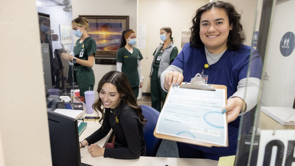The HPC lobby. Workers greet and welcome and hand someone a chart to fill out