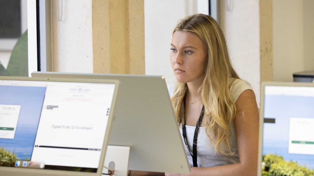 PLNU student working on computer at the Ryan Learning Center during Welcome Week.