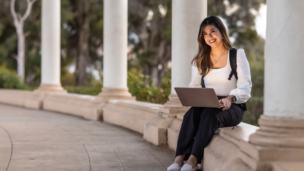 PLNU student works on her laptop for class assignment. 