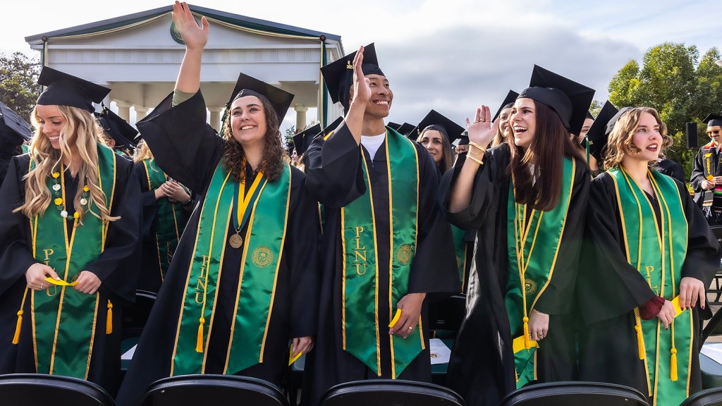 PLNU students dressed in regalia celebrating at their commencement.