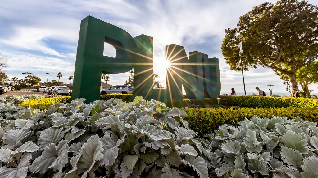 The PLNU campus sign with the sky in the background.