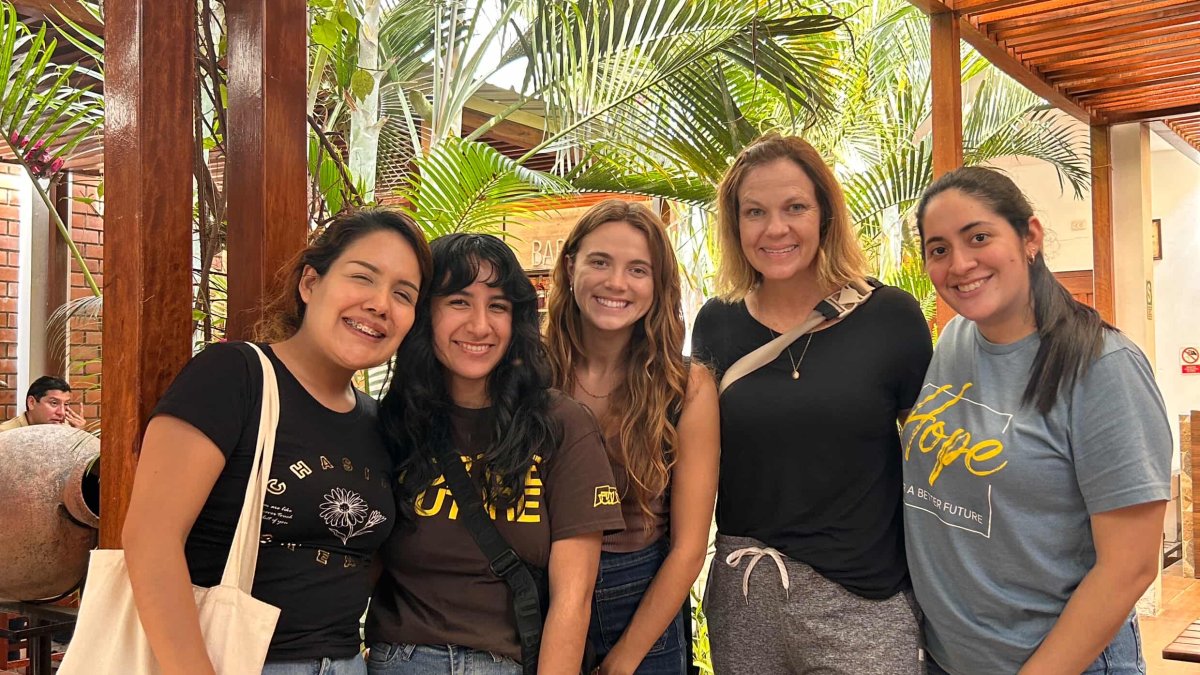 Women pose together on a trip to Peru to conduct field research. 