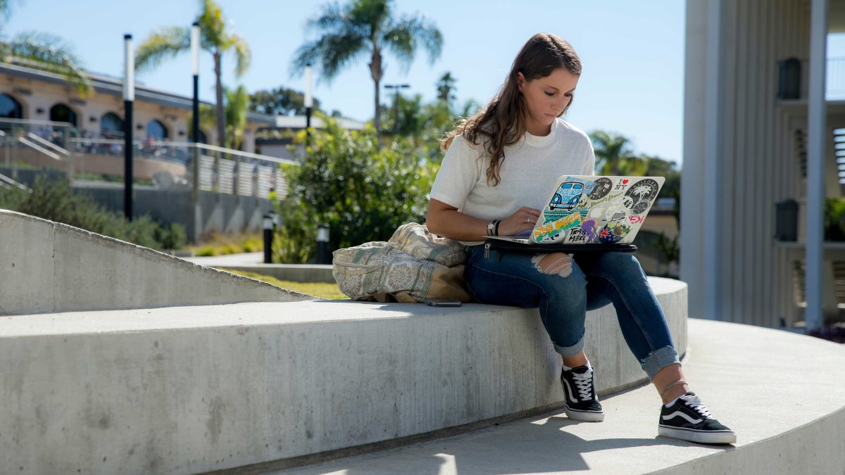 Girl working on computer outside