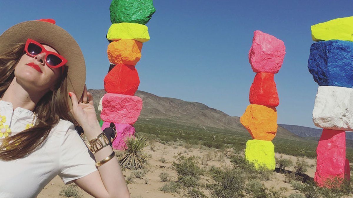Channin Fulton in the desert next to Seven Magic Mountains, by Swiss artist Ugo Rondinone.
