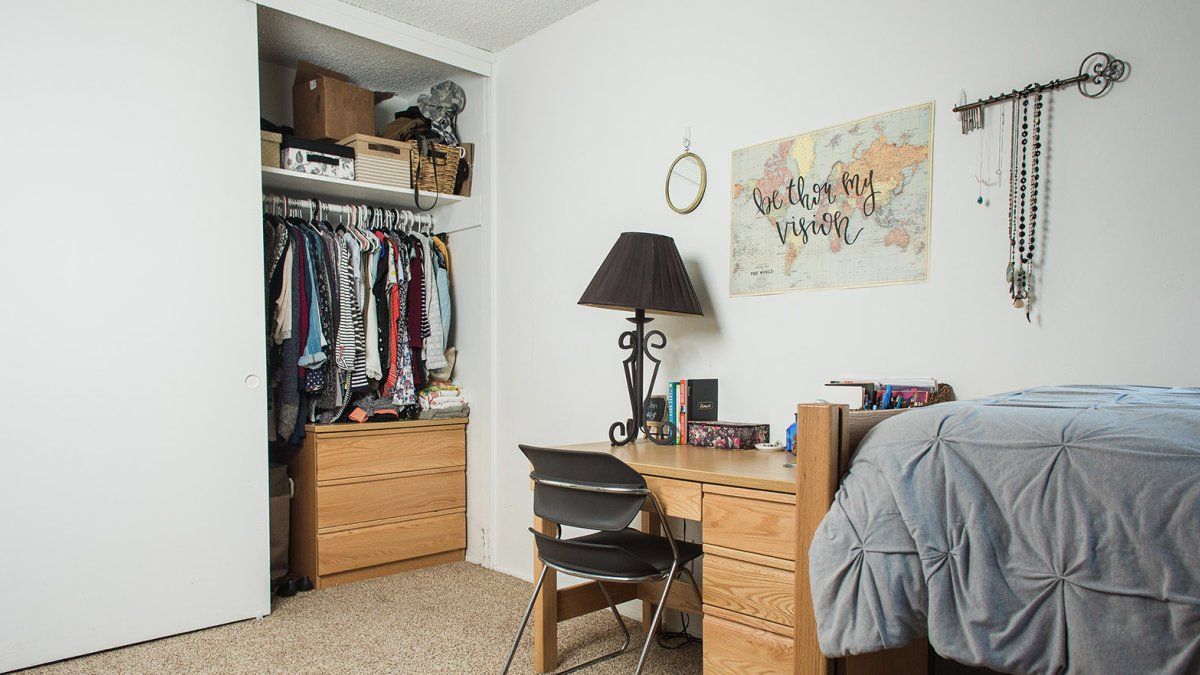 A neatly decorated and organized room in the Colony Apartments