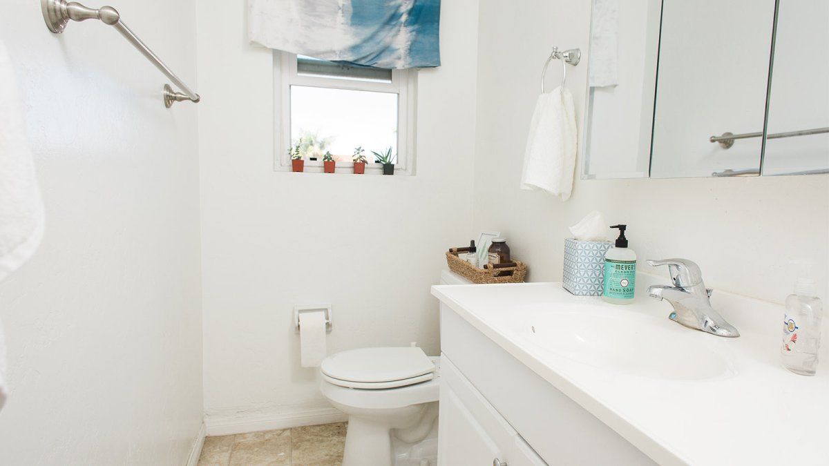 A two-person colony bathroom neatly organized and cleaned.