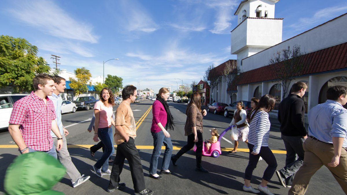 Students and teacher cross street in City Heights