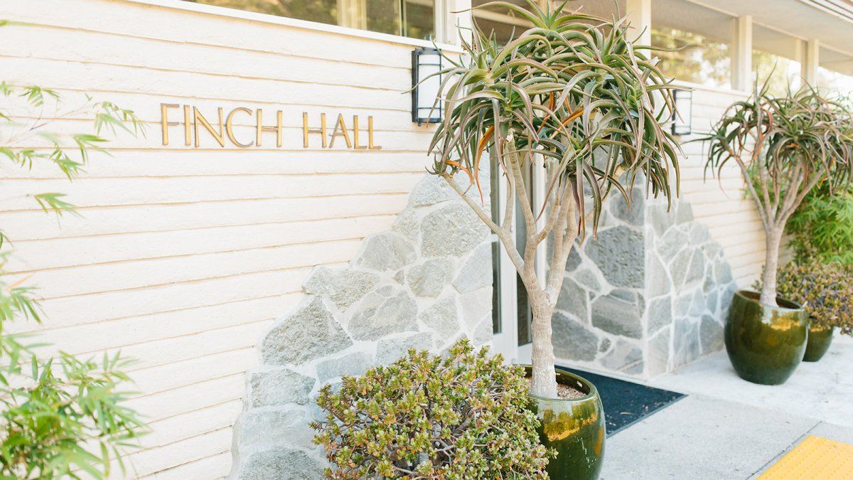 Exterior entrance of Finch Hall with green succulents.