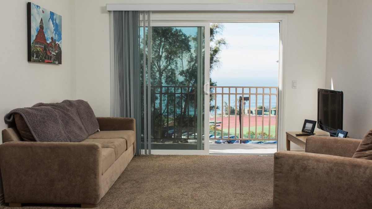 A living room in the Flex Apartments, complete with sofas and an ocean view.