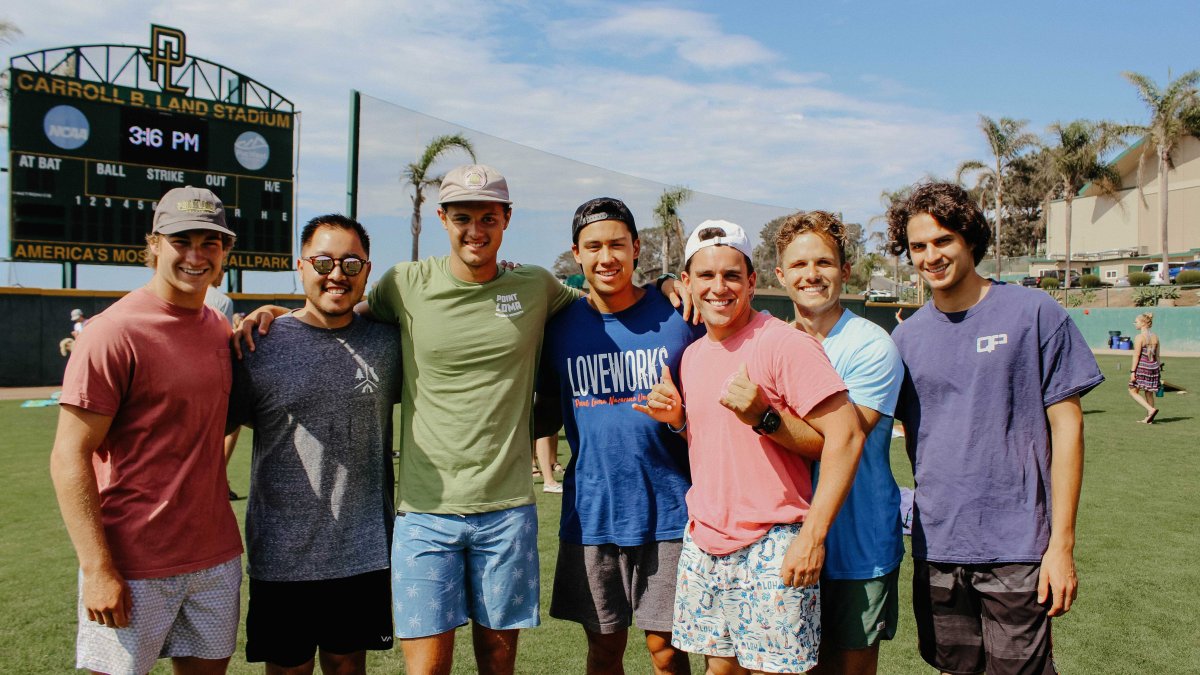 A group of male PLNU students have fun on the baseball field