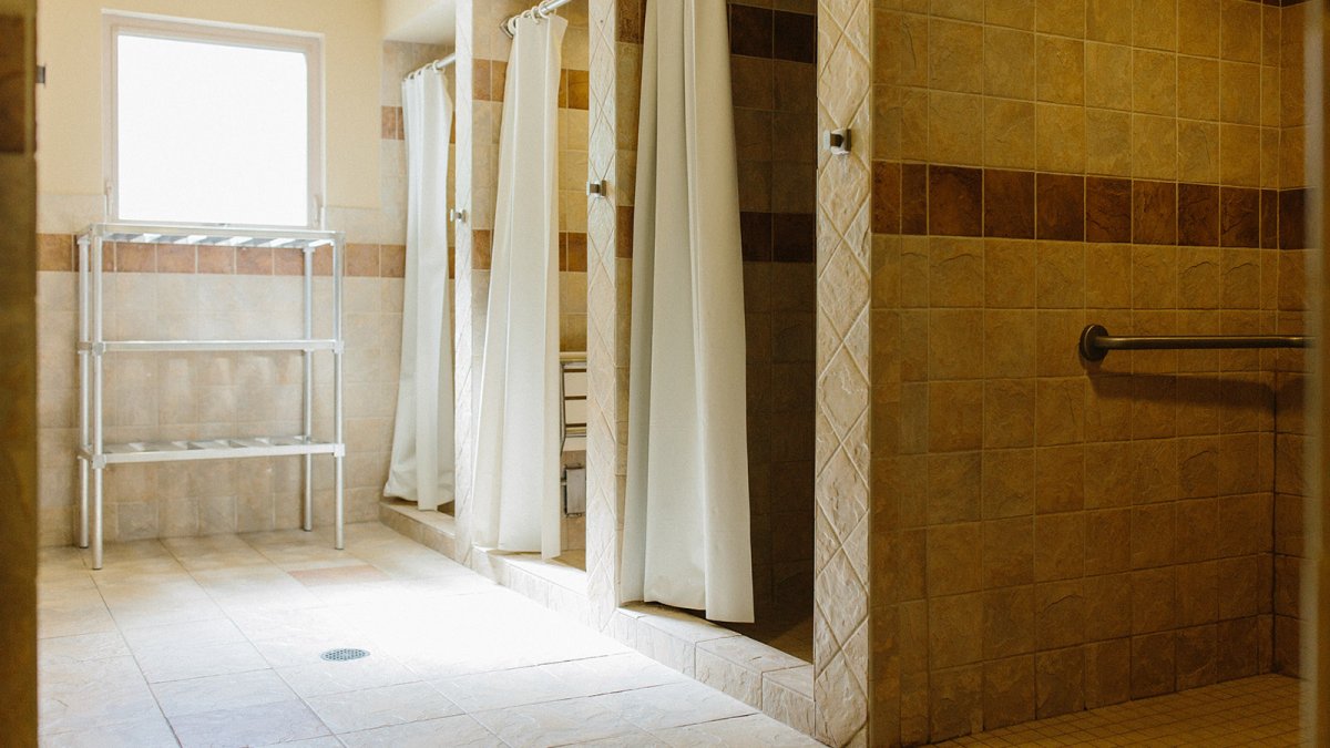 Nease West's bathrooms feature individual tiled shower stalls.