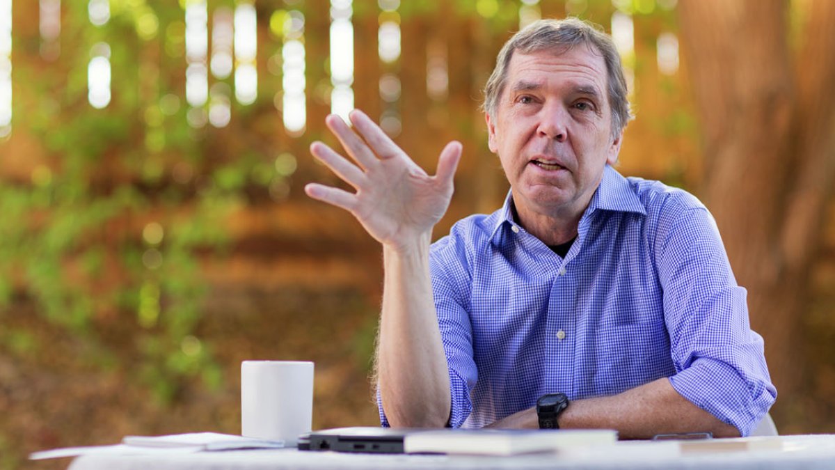 PLNU journalism professor Dr. Dean Nelson holds an interview in his backyard office.