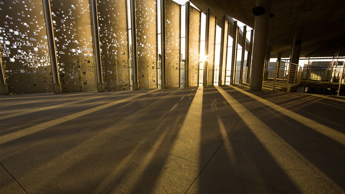 Sunset through the Alpha and Omega metal screen at Sator Hall