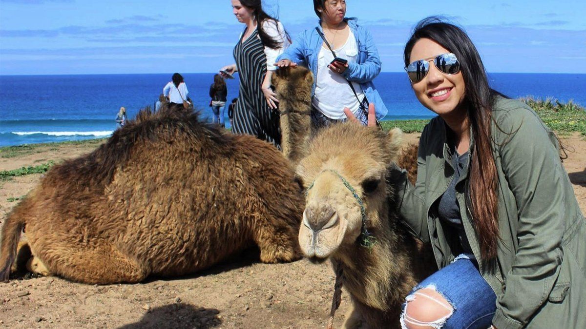 PLNU student Leslie Portillo poses next to a camel in Morocco.