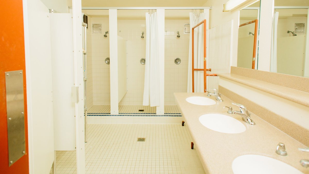 3 individual shower stalls in a Young Hall bathroom