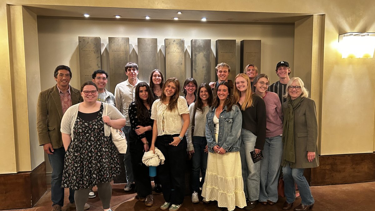 PLNU honors program students pose for a photo inside during a cultural event.