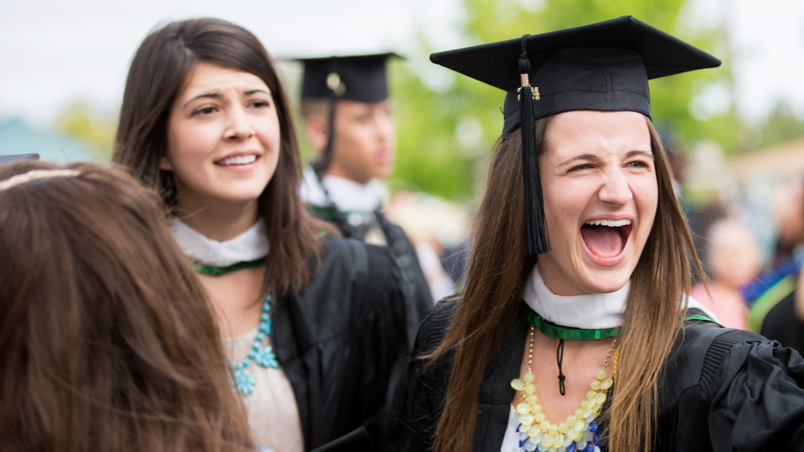 Graduate student celebrates after receiving her diploma