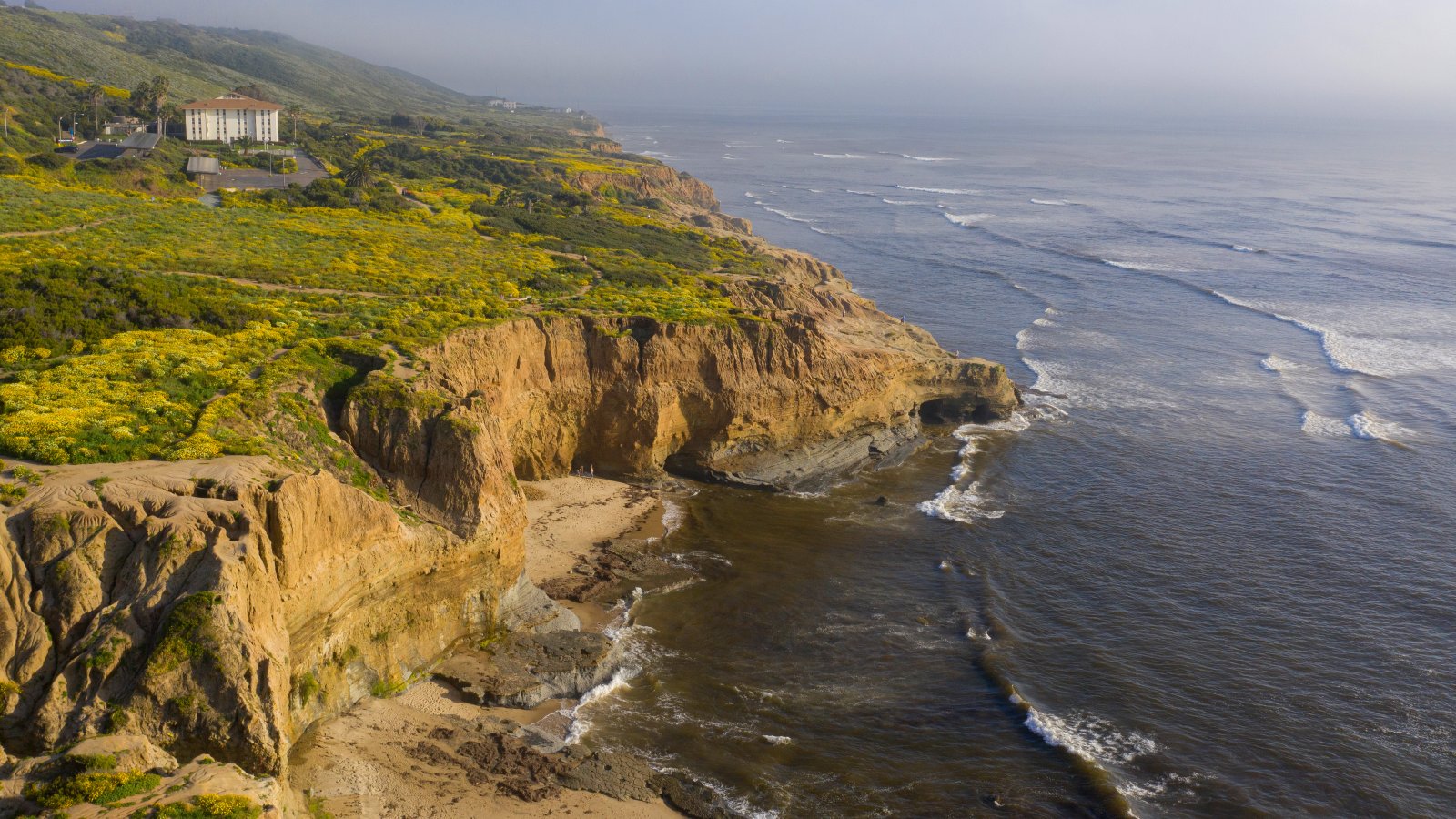 Aerial view overlooking Young Hall with the rugged coastline off the campus of PLNU