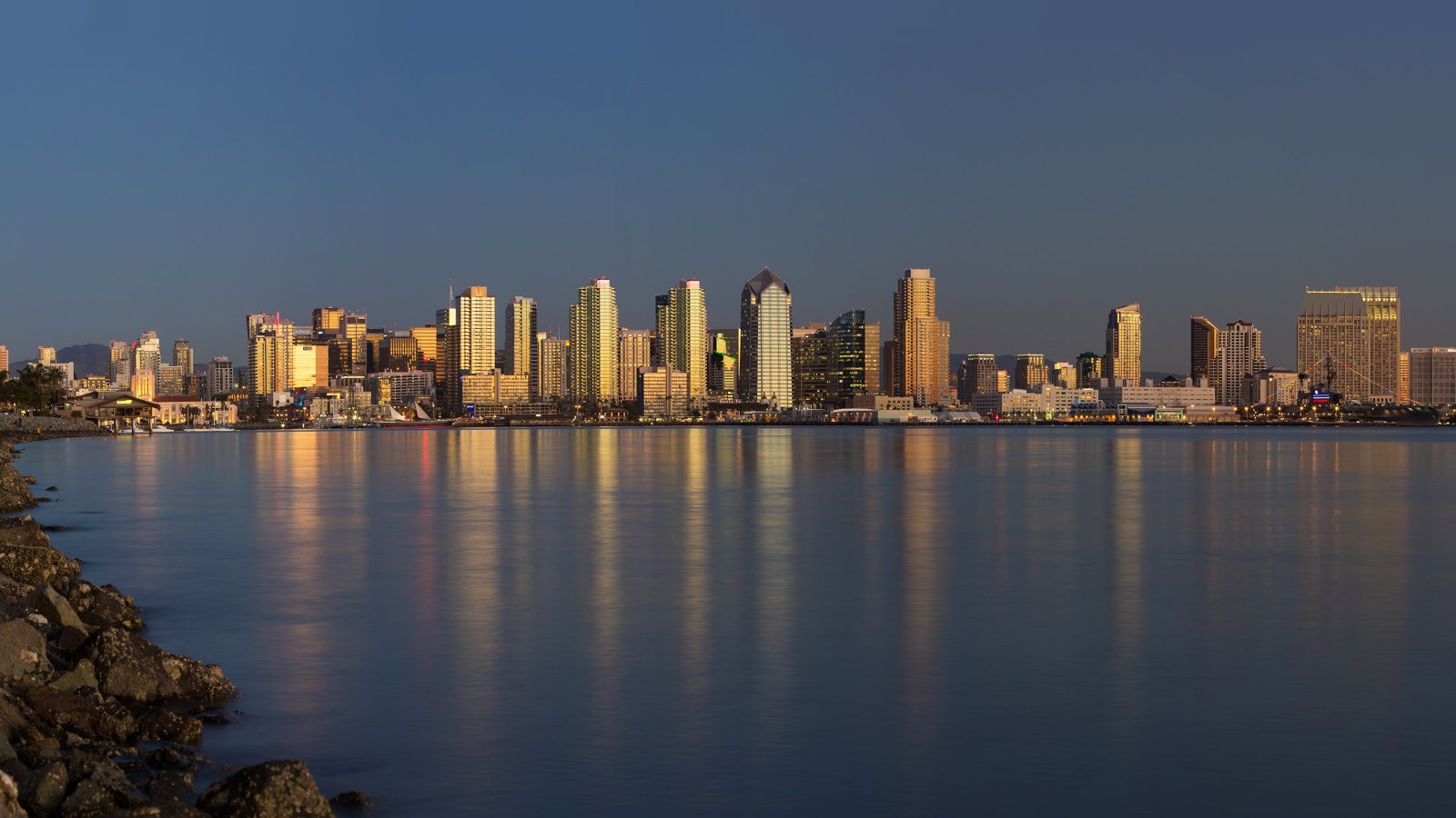 San Diego Skyline In The Background of San Diego Bay Lit By A Sunset
