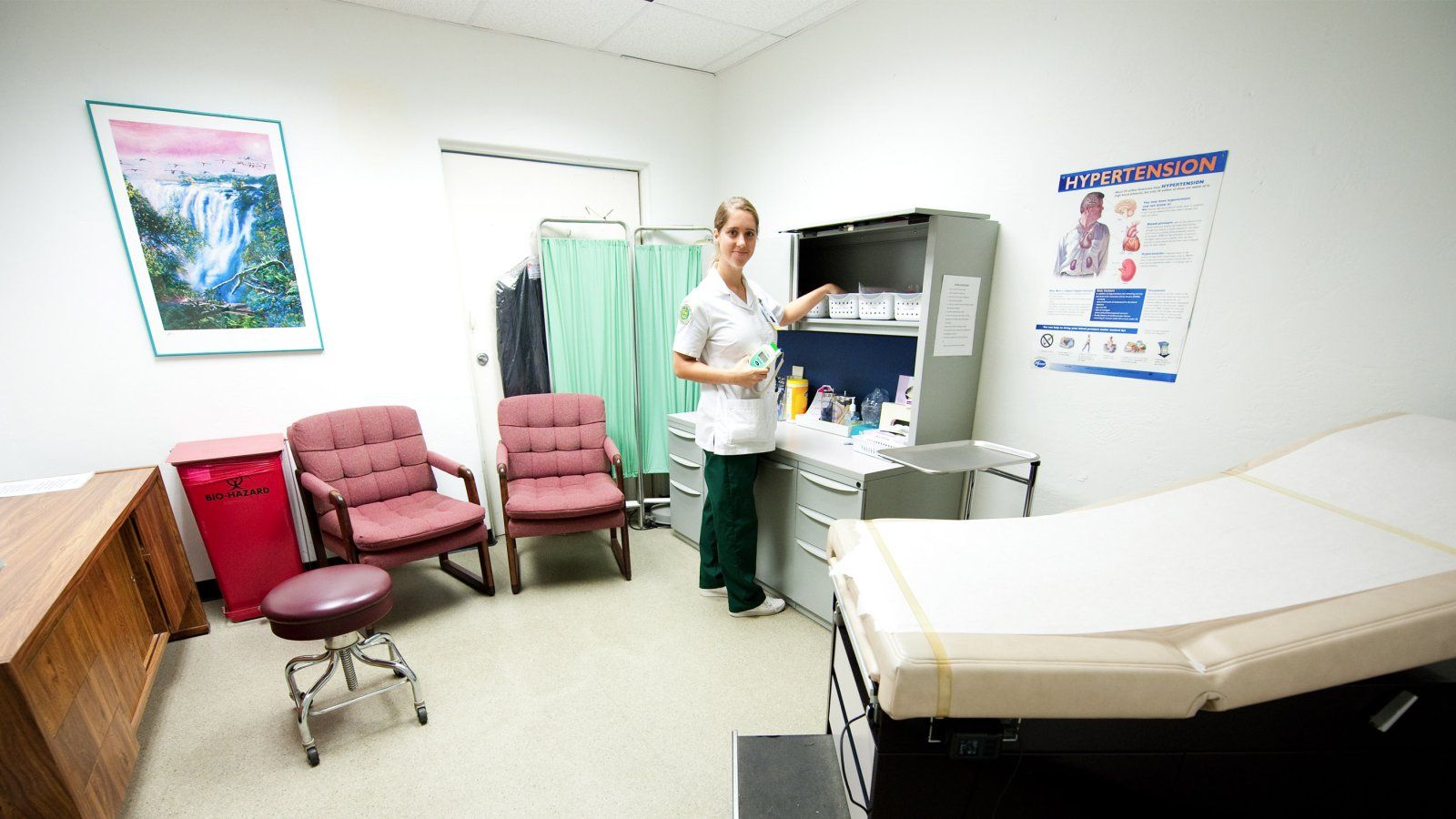 A PLNU nursing student checks supplies in a patient waiting room at the Health Promotion Center.