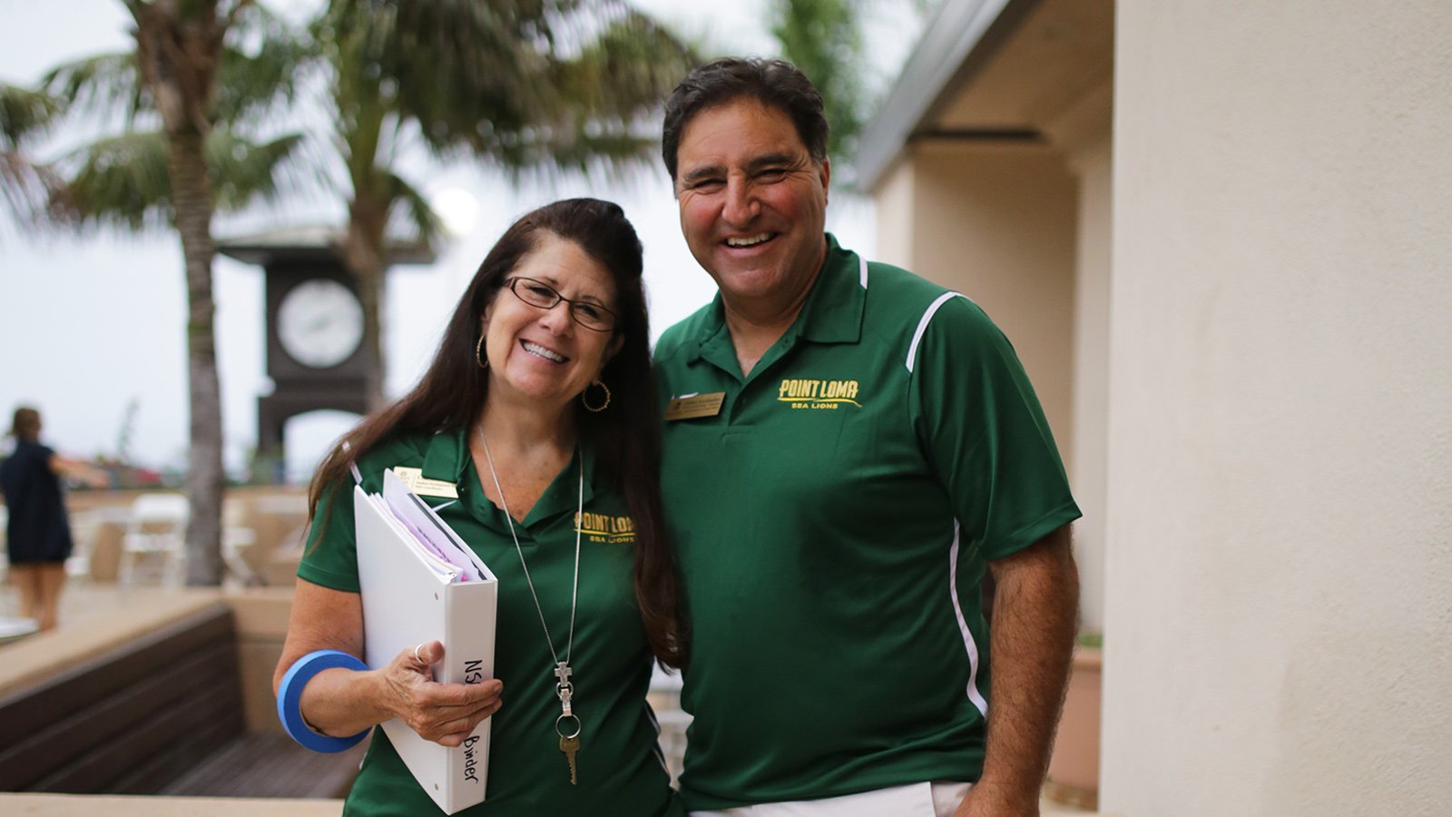Two PLNU staff take a break during NSO and pose for a picture in front of the caf.