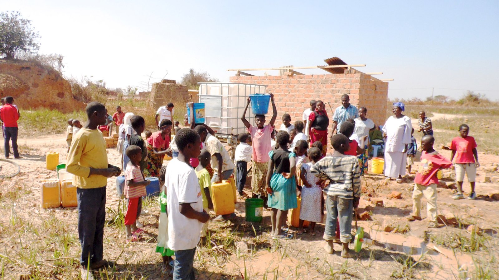 A group of families drawing water from a well in the Democratic Republic of Congo.