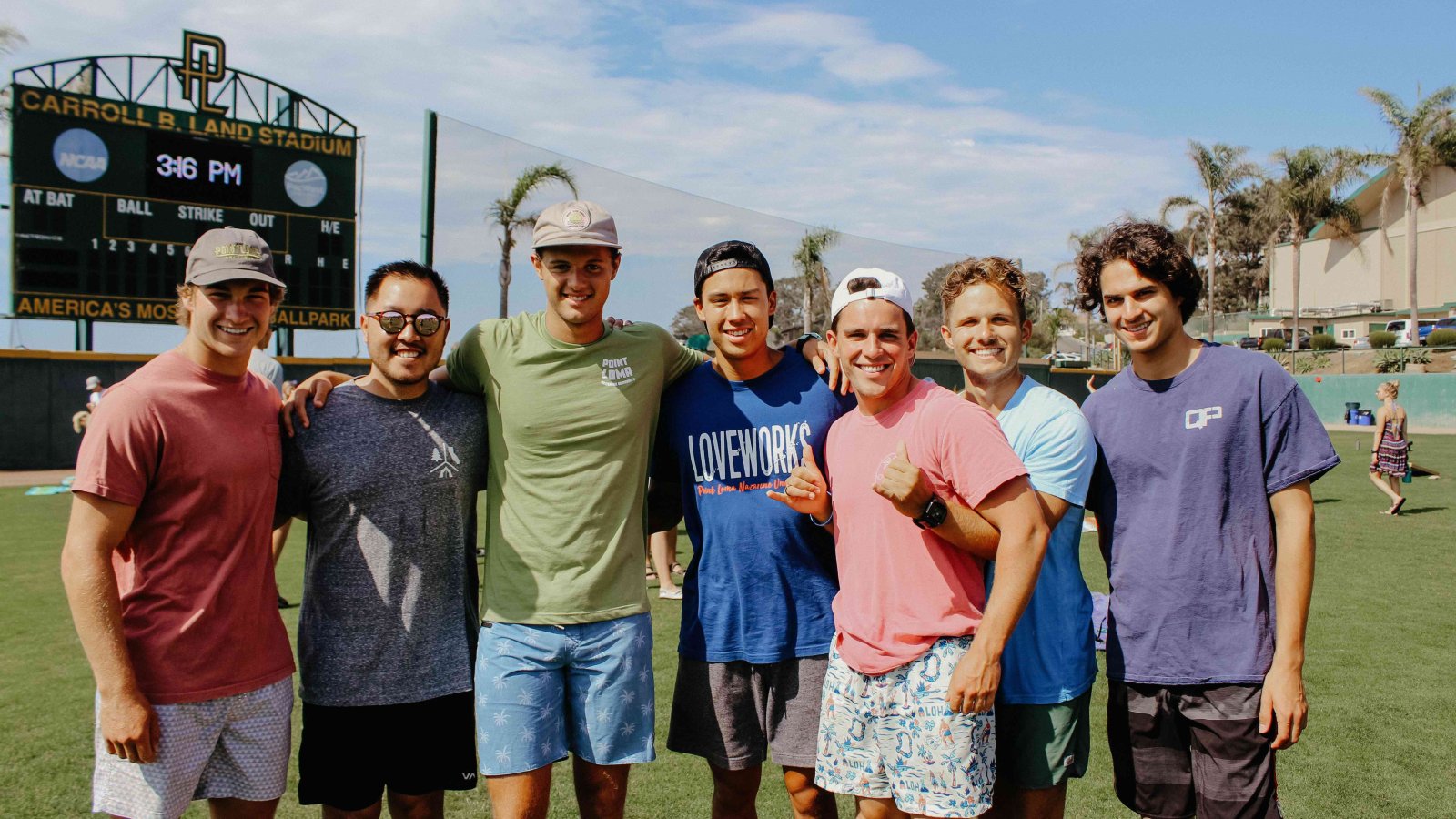 A group of male PLNU students pose for a photo outside 