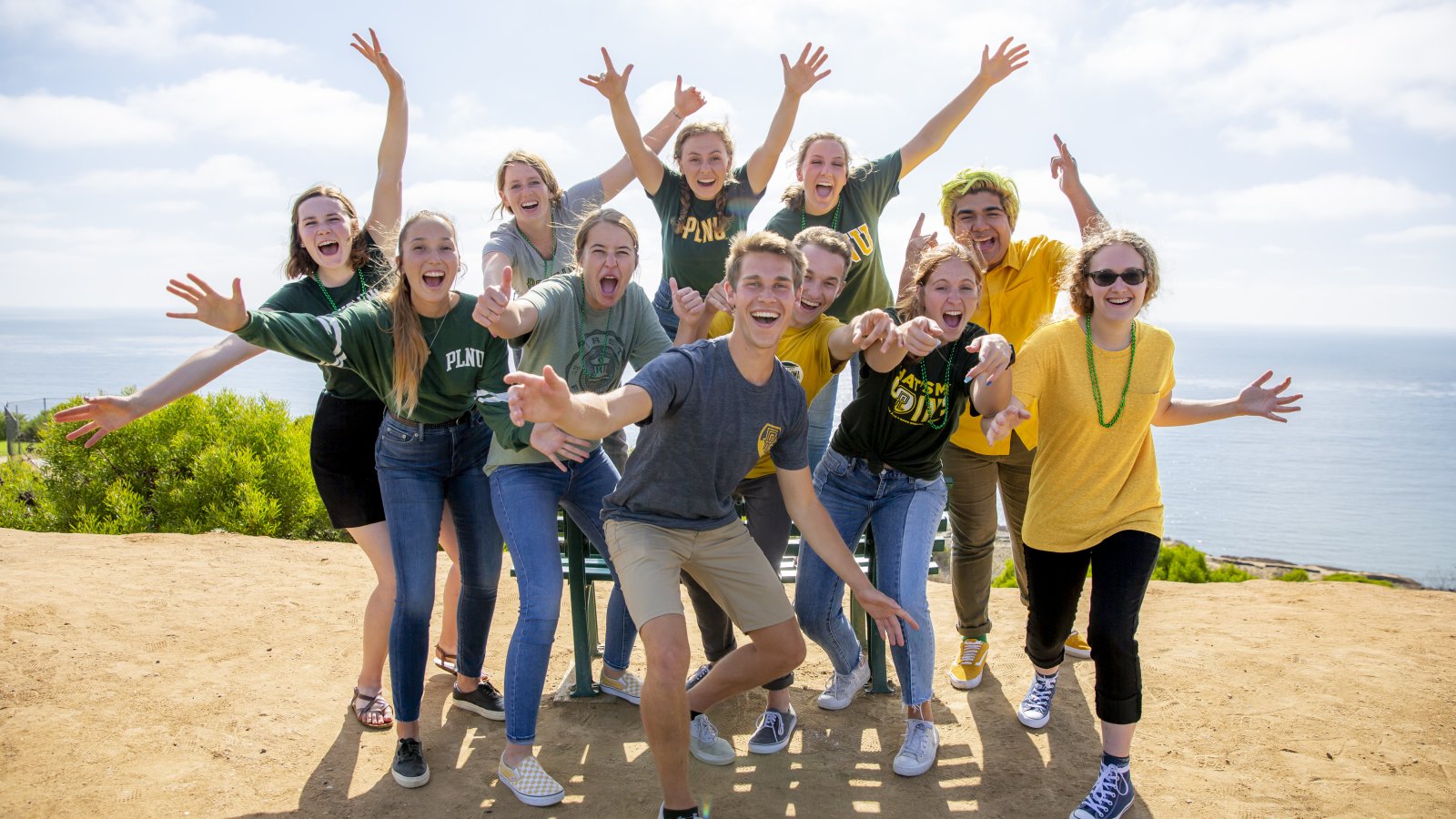 Group of PLNU students cheer and smile