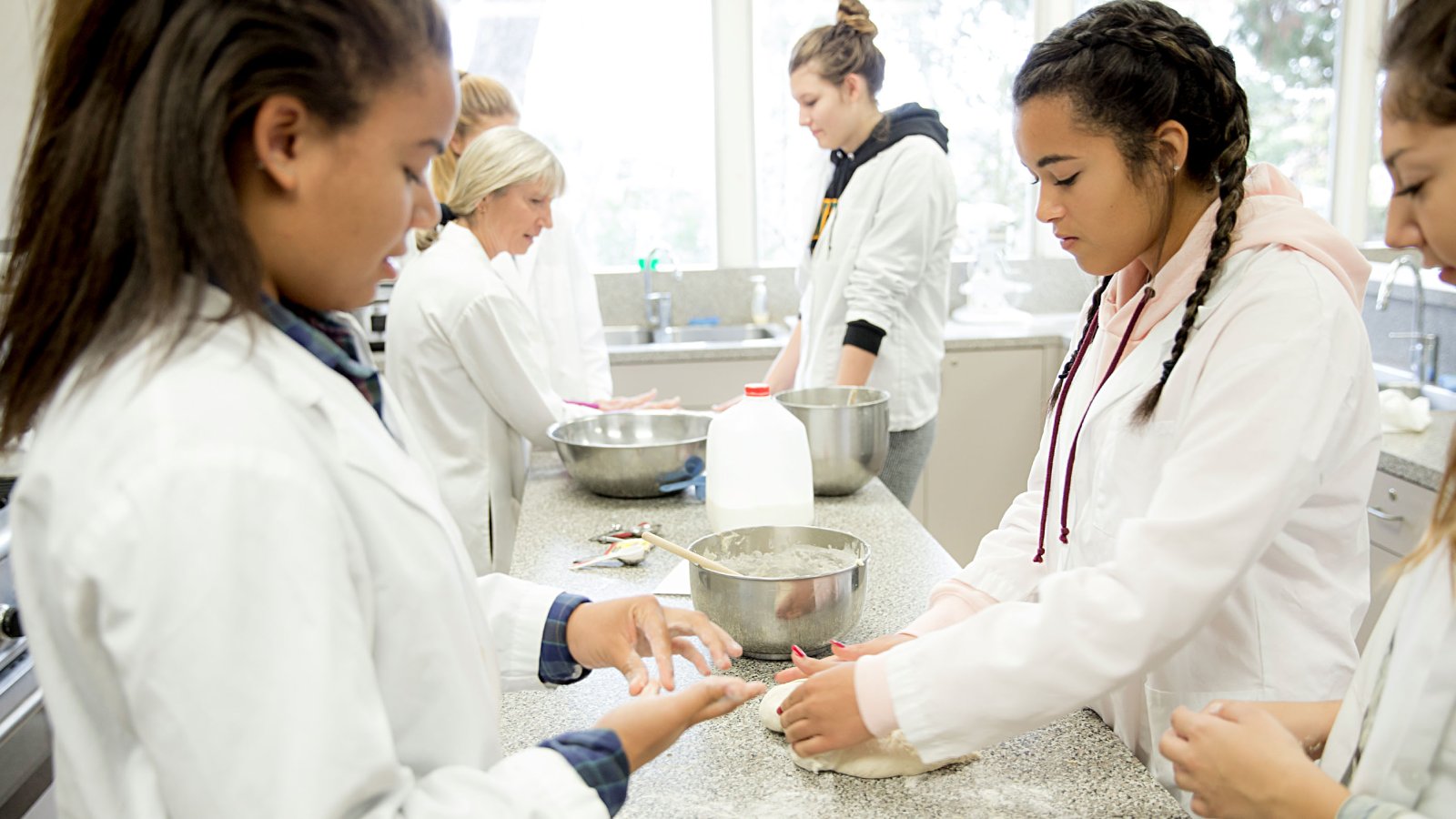 Students in Lab Coats Conducting Research