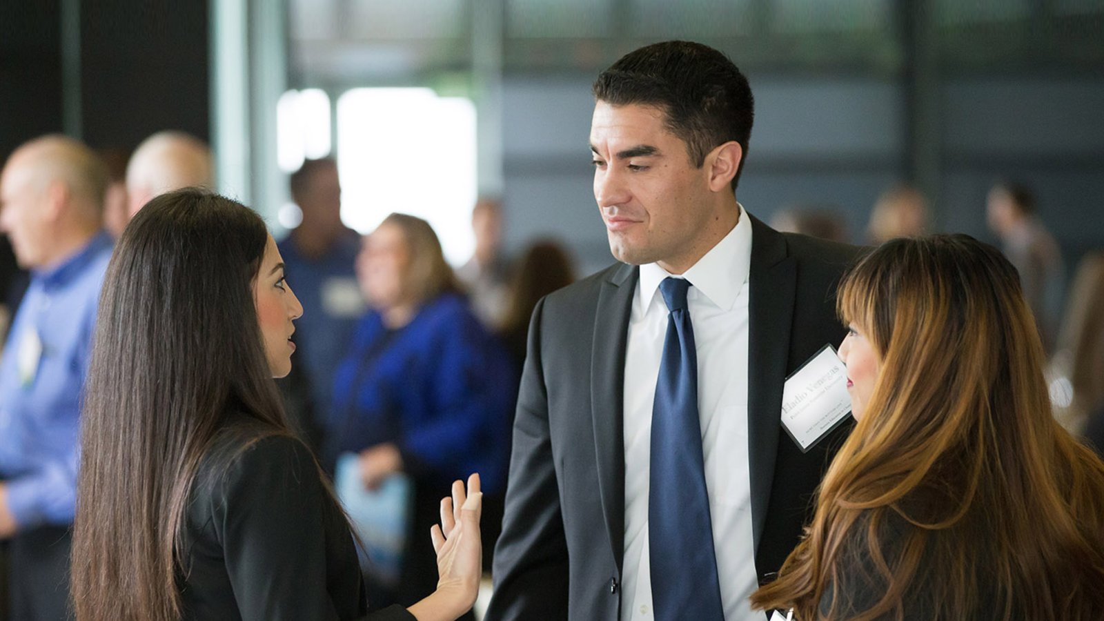 PLNU students network with a business professional at an OSV event.