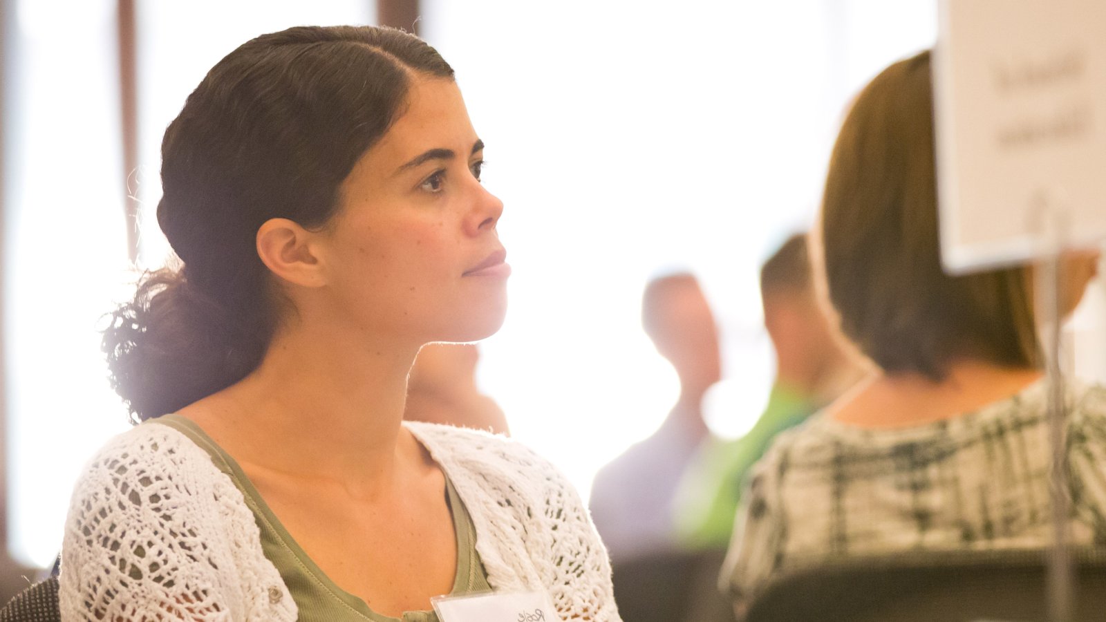 Graduate student listens to presentation during Graduate Student Orientation