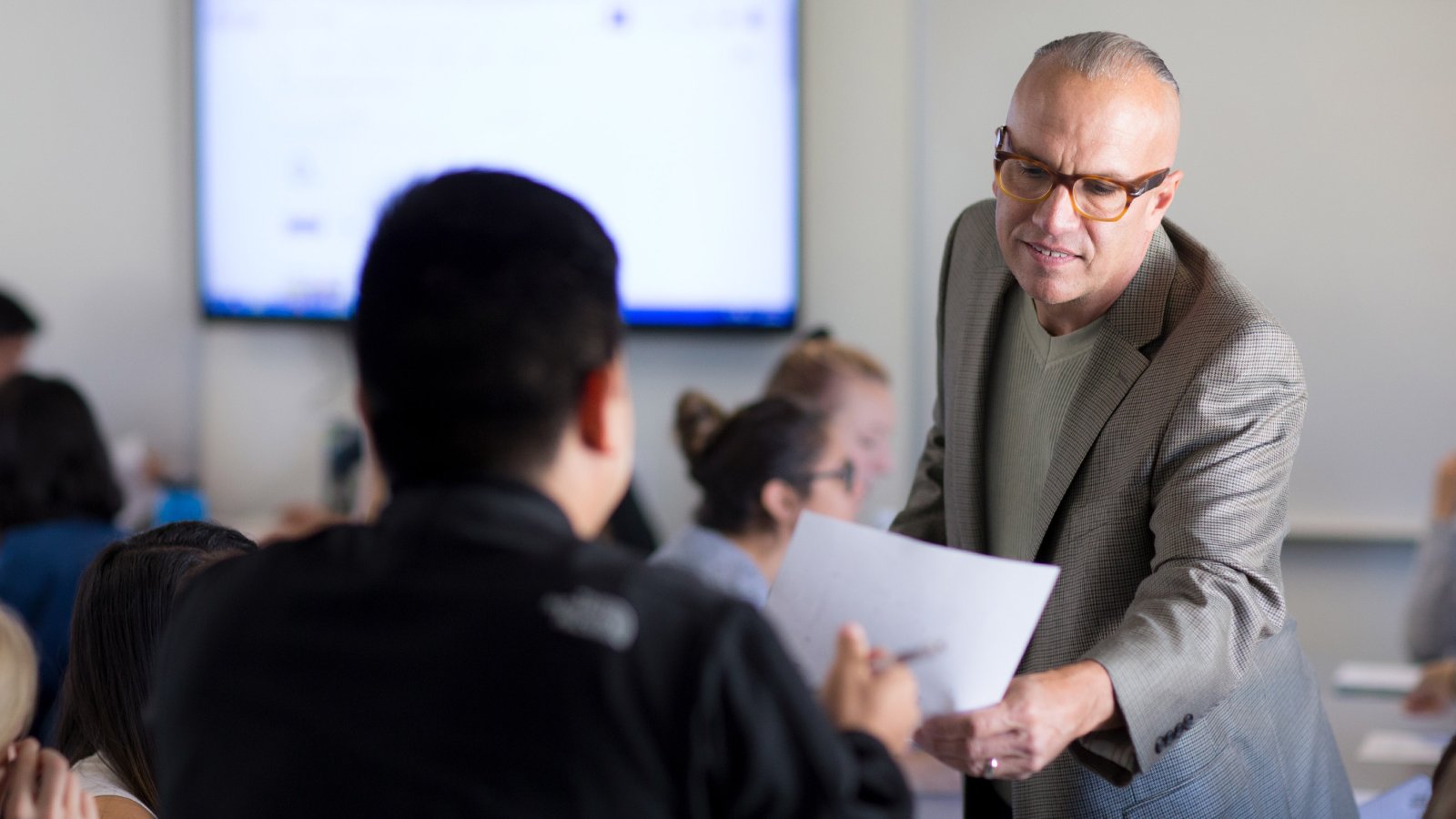 Professor Kim Schaefer helps student during class