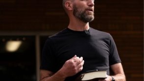 Dr. Jamie Johnson preaches holding the Bible