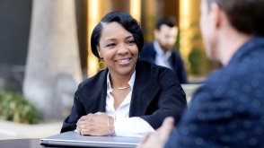 Adult business students talking at a table