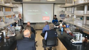 Students presenting to biotech scientists.