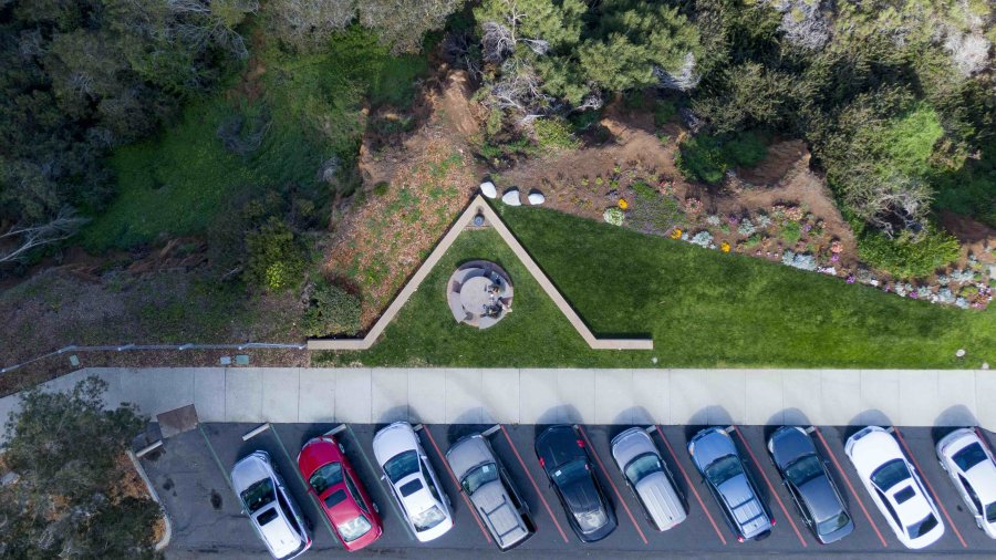 A drone view of cars parked on PLNU's campus