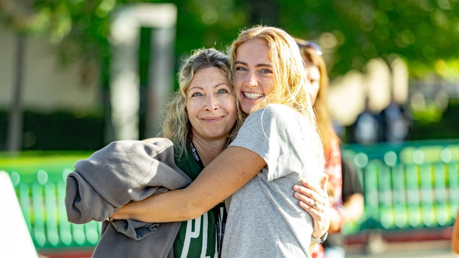 Smiling PLNU student hugging her mom