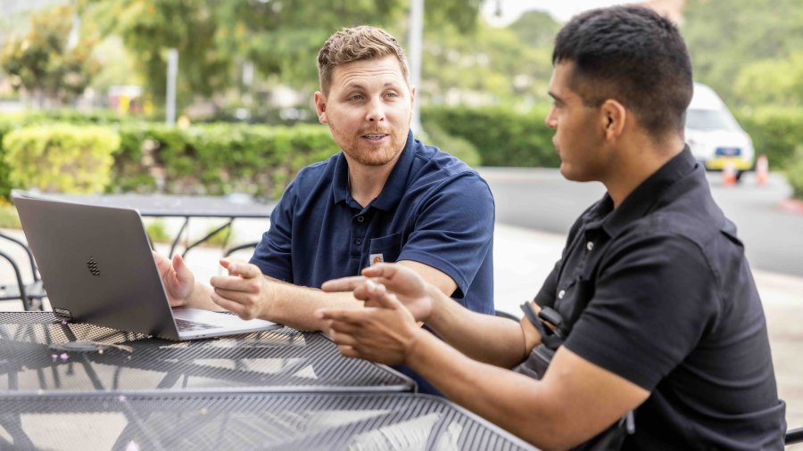 Two PLNU military students work outside together.