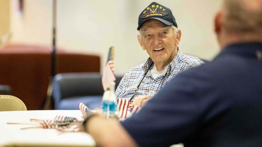 Military veteran connects with table mate at Warrior Breakfast.